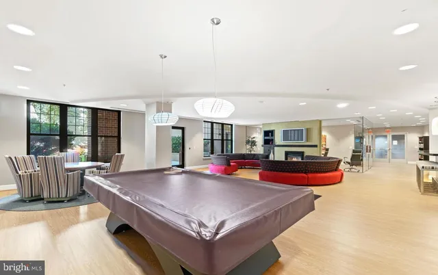 a living room with furniture a flat screen tv and a large window