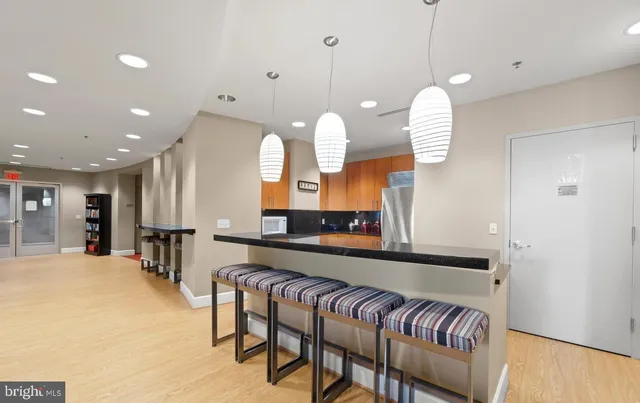 a kitchen with a table chairs and a chandelier