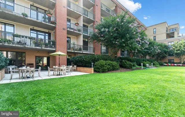 a view of a patio with couches table and chairs and potted plants