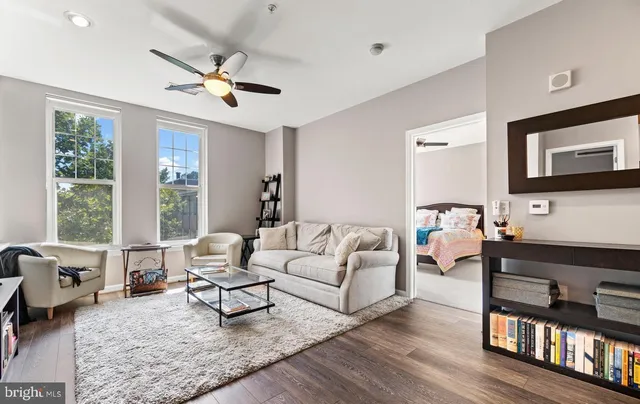 a living room with furniture and wooden floor