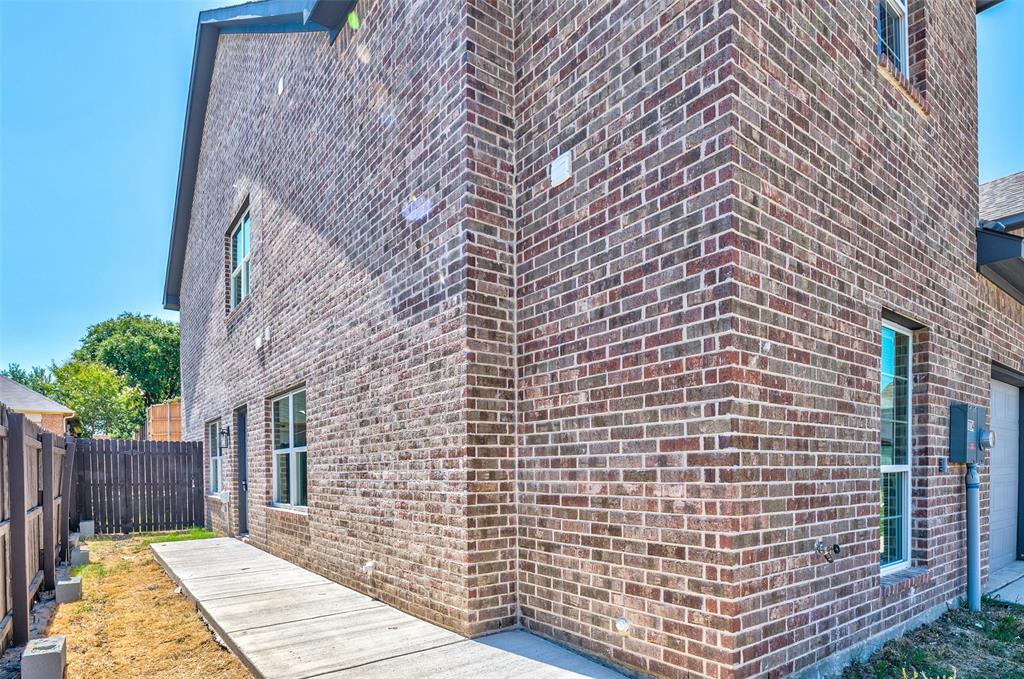 a view of a brick wall of the house