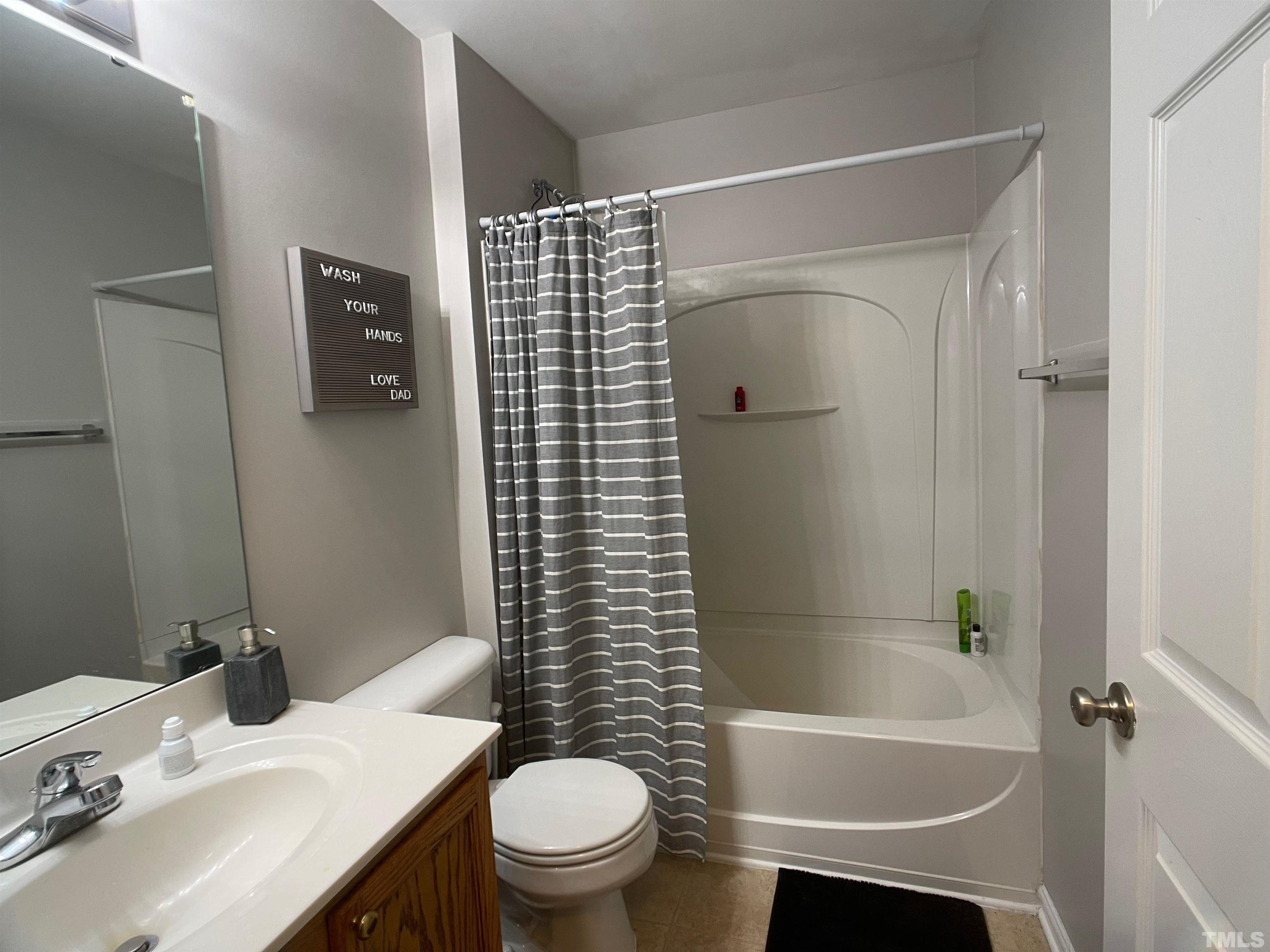 11710 Mezzanine Drive, Unit 101 Raleigh, NC 27614 - Photo 16 of 23 a bathroom with a sink toilet and shower