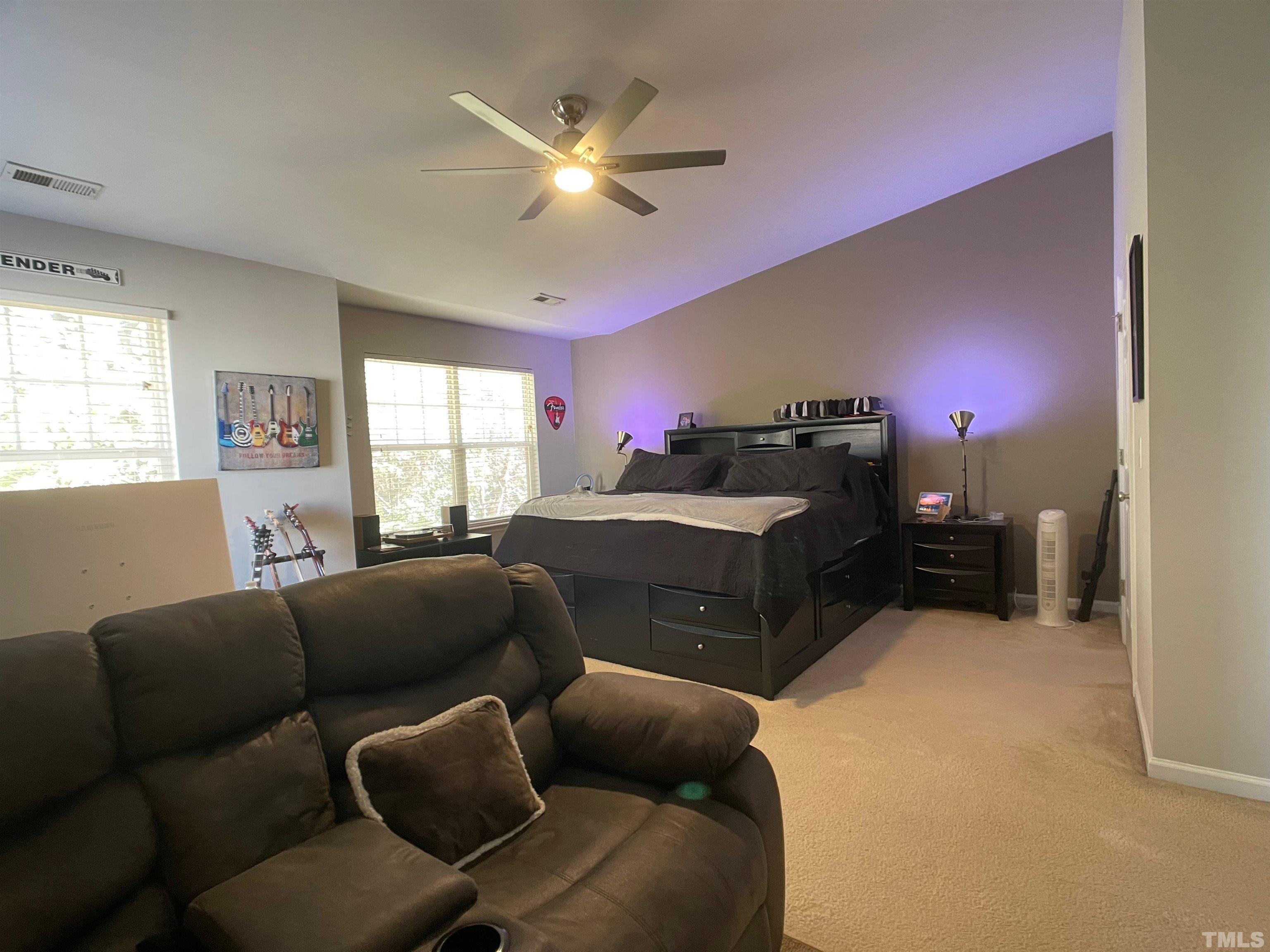 11710 Mezzanine Drive, Unit 101 Raleigh, NC 27614 - Photo 17 of 23 a living room with furniture a chandelier and a window