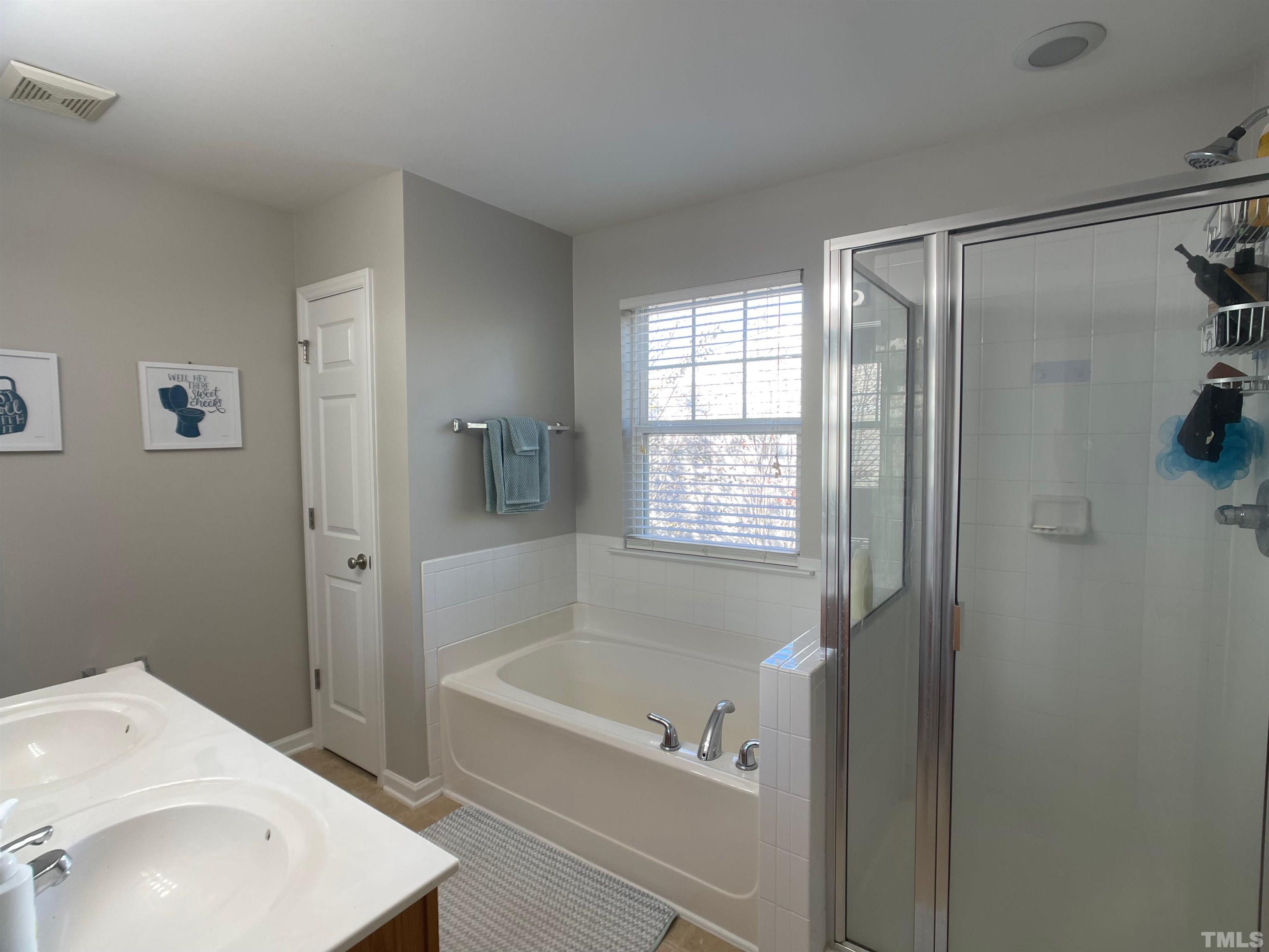 11710 Mezzanine Drive, Unit 101 Raleigh, NC 27614 - Photo 18 of 23 a bathroom with a sink a toilet and shower