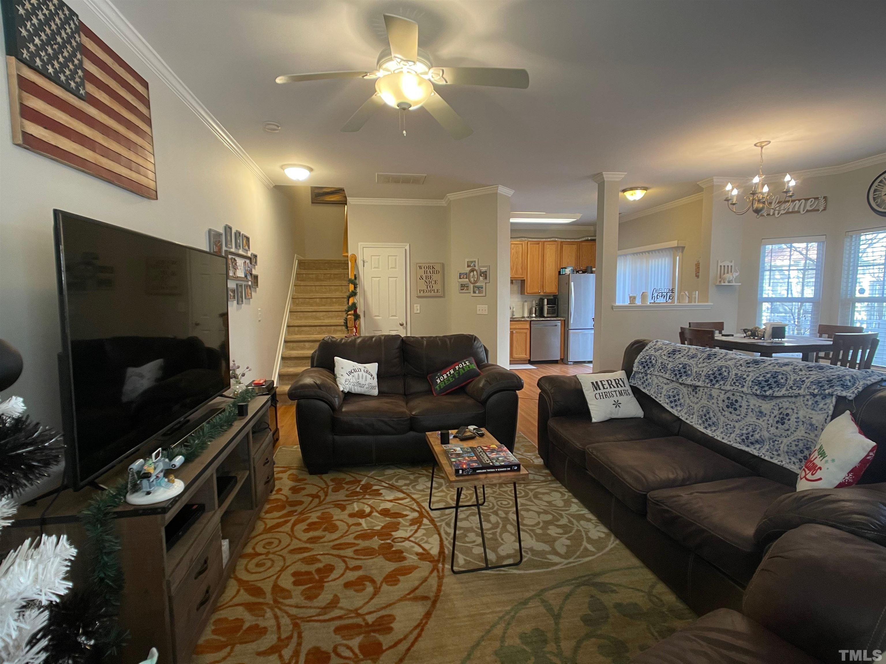 11710 Mezzanine Drive, Unit 101 Raleigh, NC 27614 - Photo 3 of 23 a living room with furniture and a flat screen tv