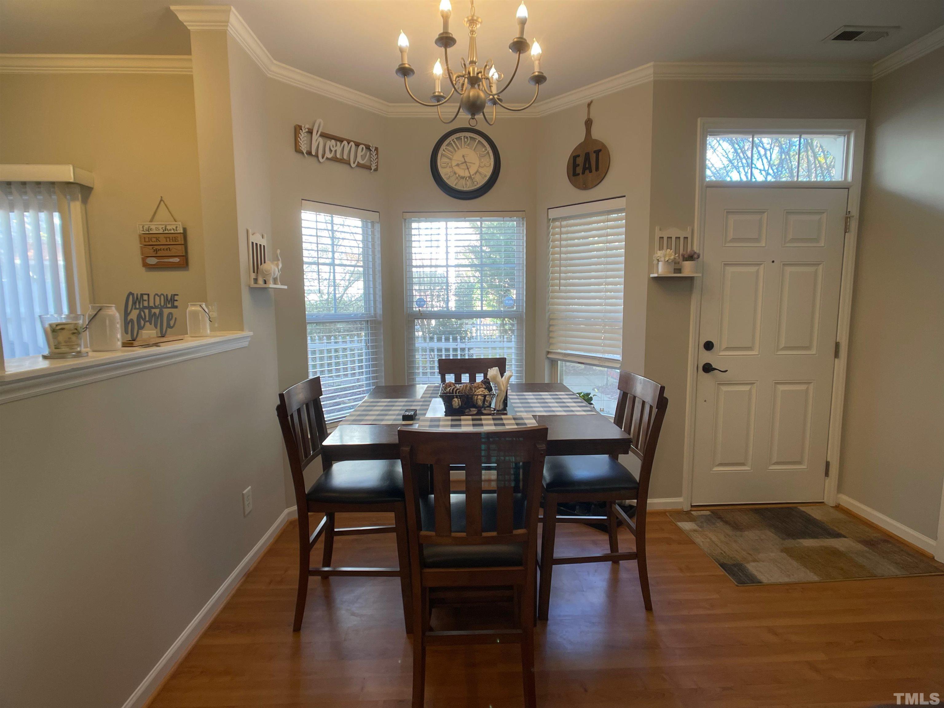 11710 Mezzanine Drive, Unit 101 Raleigh, NC 27614 - Photo 6 of 23 a view of a dining room with furniture window and wooden floor