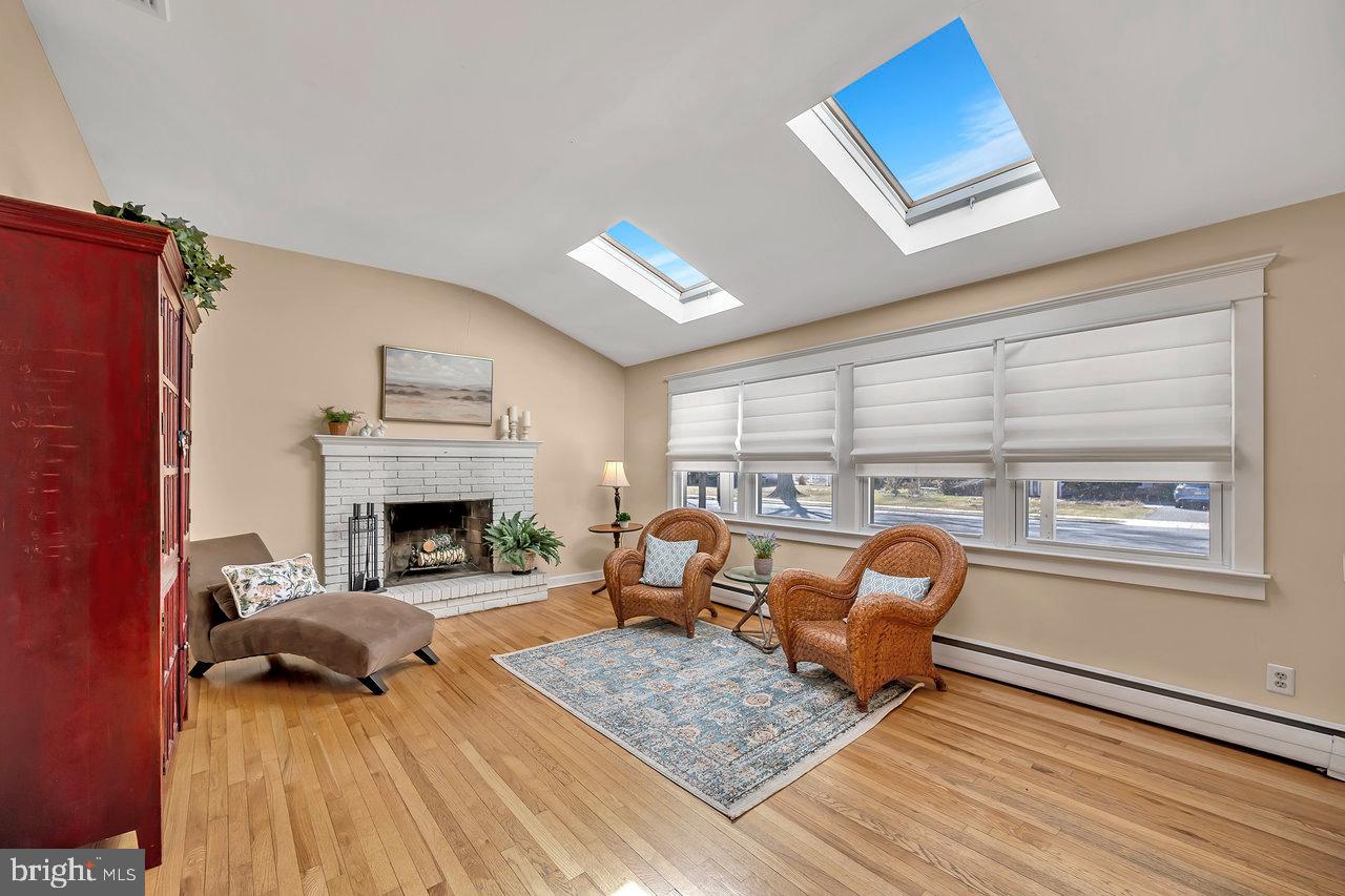 23 Griggs Road Cranbury, NJ 08512 - Photo 11 of 40 a living room with furniture and a fireplace