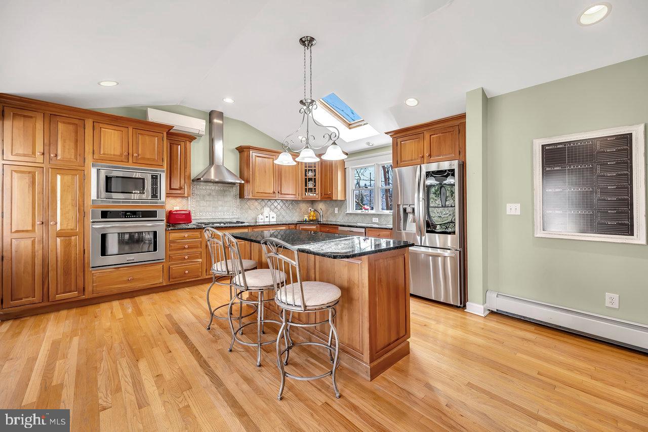 23 Griggs Road Cranbury, NJ 08512 - Photo 17 of 40 a kitchen with stainless steel appliances kitchen island granite countertop a stove a sink a refrigerator and cabinets