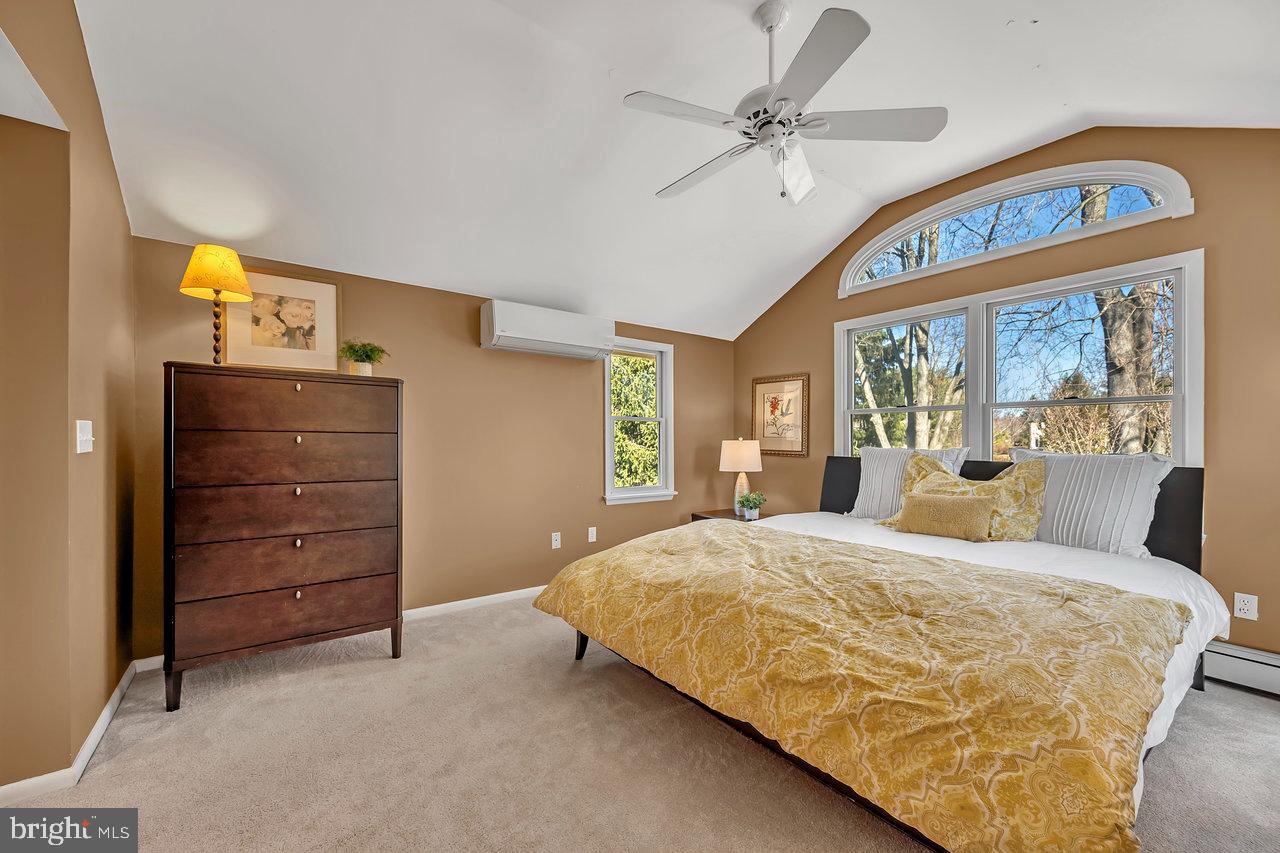 23 Griggs Road Cranbury, NJ 08512 - Photo 23 of 40 a bedroom with a large bed and a chandelier