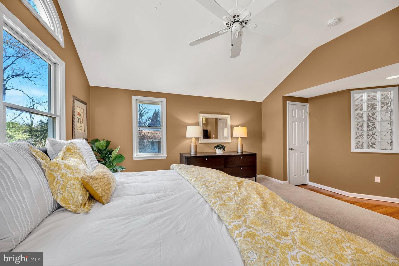 23 Griggs Road Cranbury, NJ 08512 - Photo 24 of 40 a bedroom with a large bed and a chandelier