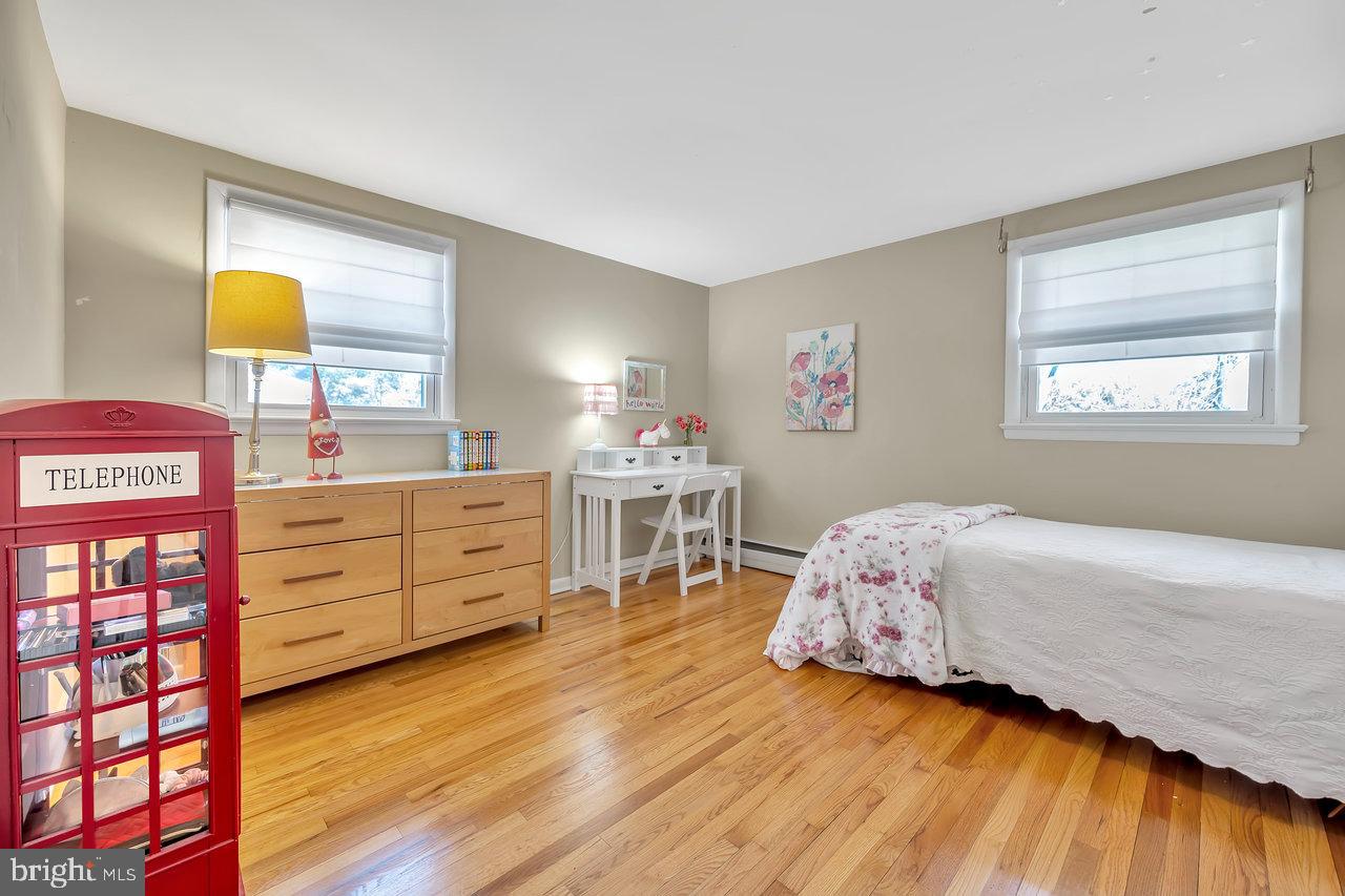 23 Griggs Road Cranbury, NJ 08512 - Photo 27 of 40 a bedroom with a bed and wooden floor