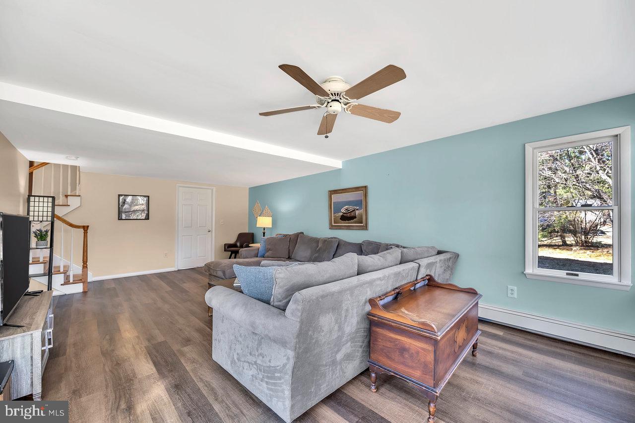 23 Griggs Road Cranbury, NJ 08512 - Photo 31 of 40 a living room with furniture a ceiling fan and a window