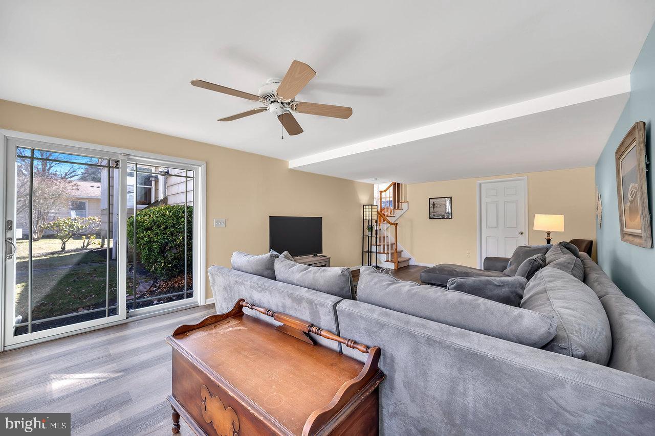 23 Griggs Road Cranbury, NJ 08512 - Photo 32 of 40 a living room with furniture a ceiling fan and a window