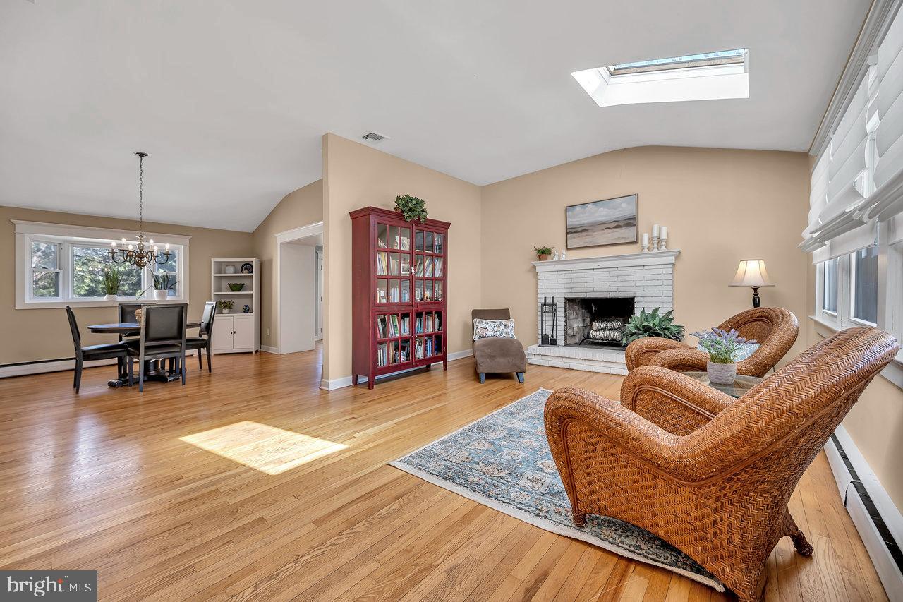 23 Griggs Road Cranbury, NJ 08512 - Photo 10 of 40 a living room with furniture and a fireplace