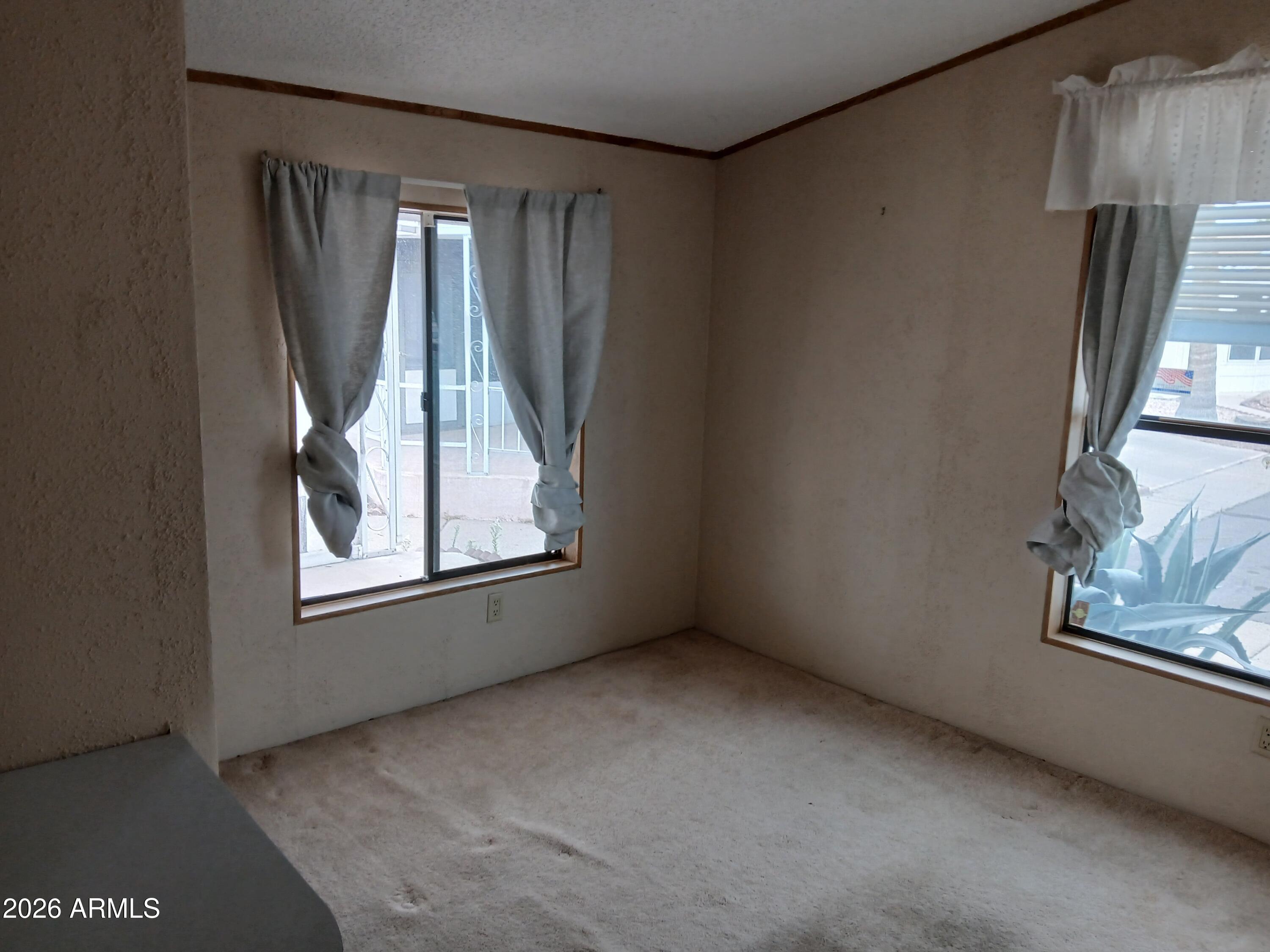834 South Meridian Road, Unit 162 Apache Junction, AZ 85120 - Photo 12 of 32 a view of an empty room with a window
