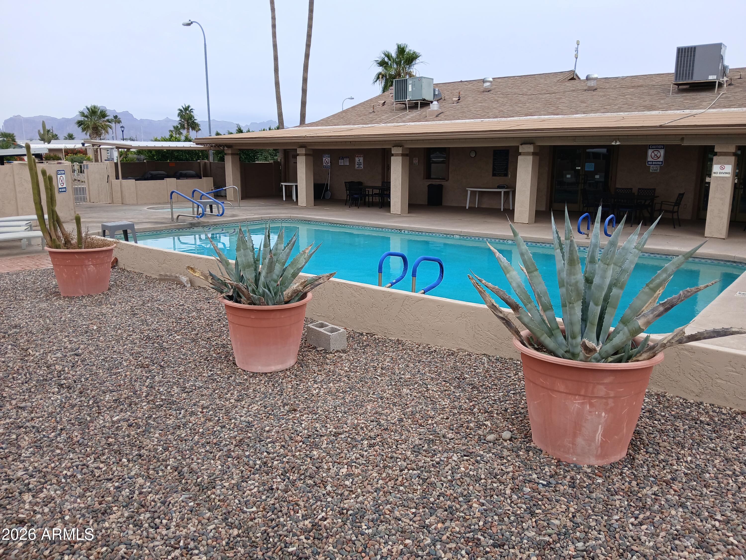 834 South Meridian Road, Unit 162 Apache Junction, AZ 85120 - Photo 28 of 32 a view of a small house with potted plants