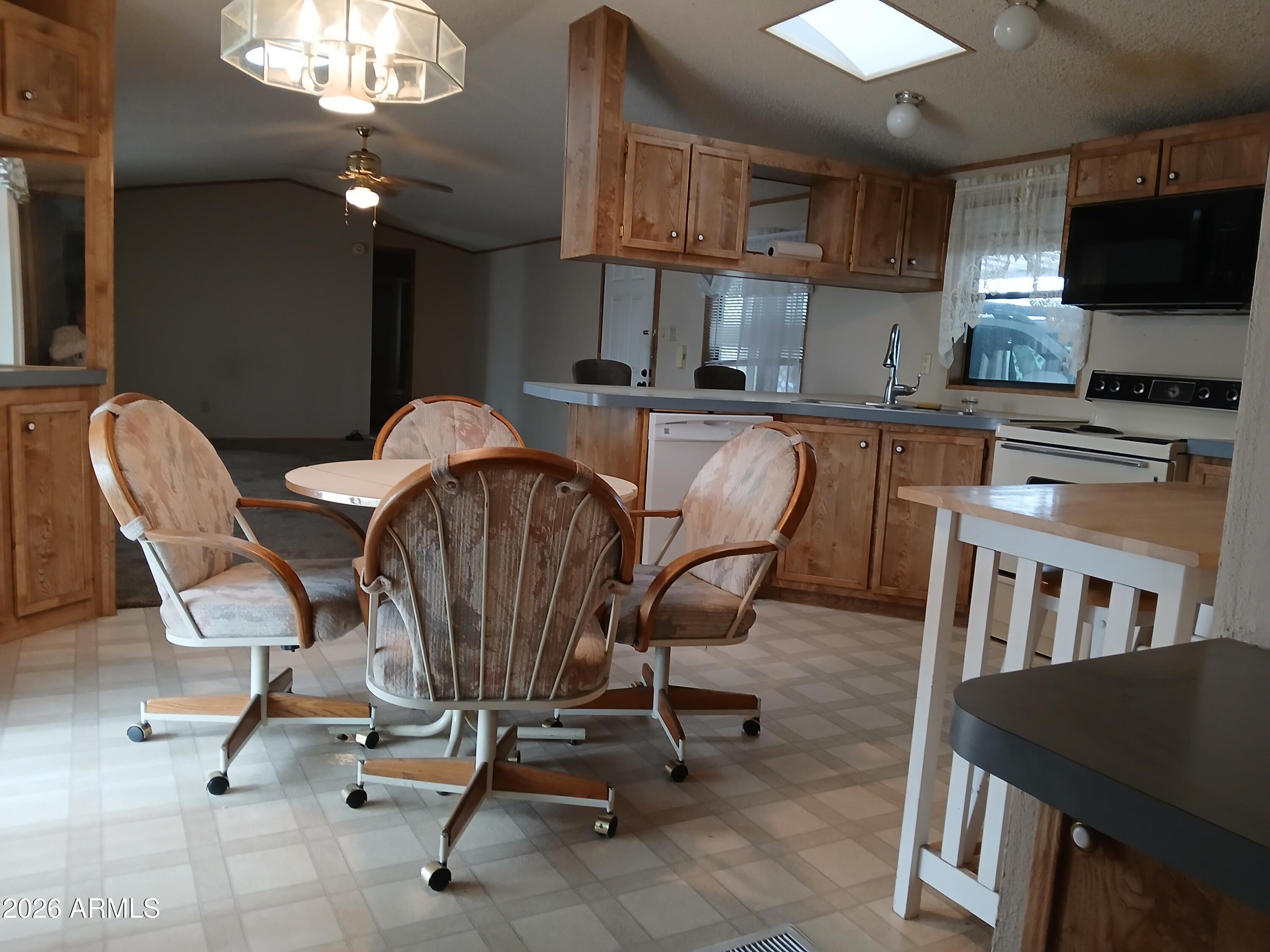 834 South Meridian Road, Unit 162 Apache Junction, AZ 85120 - Photo 4 of 32 a dining room with furniture and a kitchen view