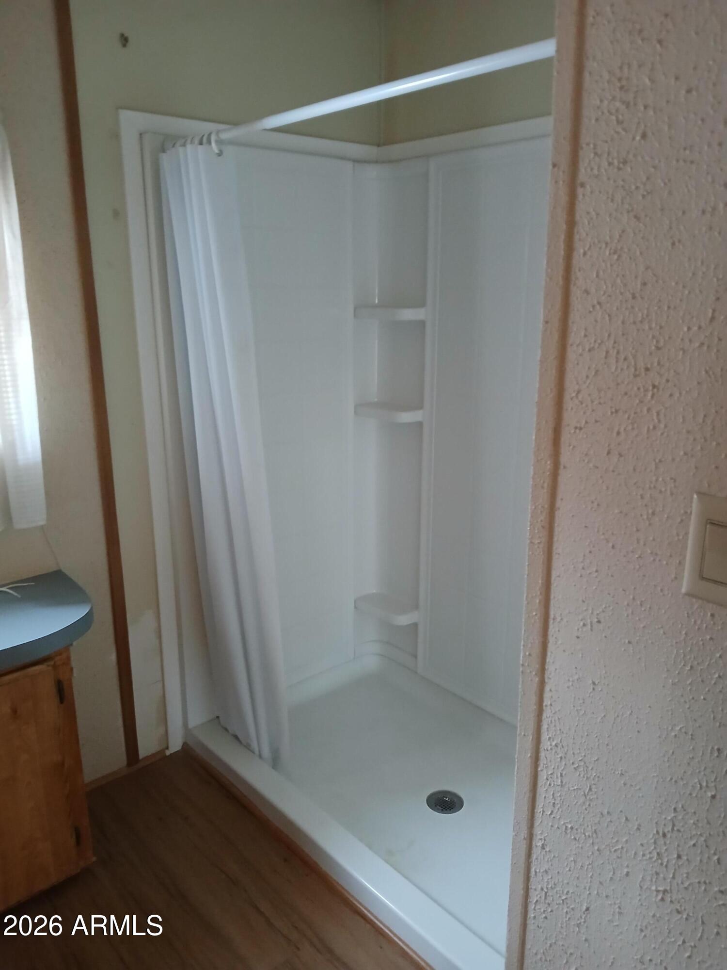 834 South Meridian Road, Unit 162 Apache Junction, AZ 85120 - Photo 10 of 32 a bathroom with a glass shower door