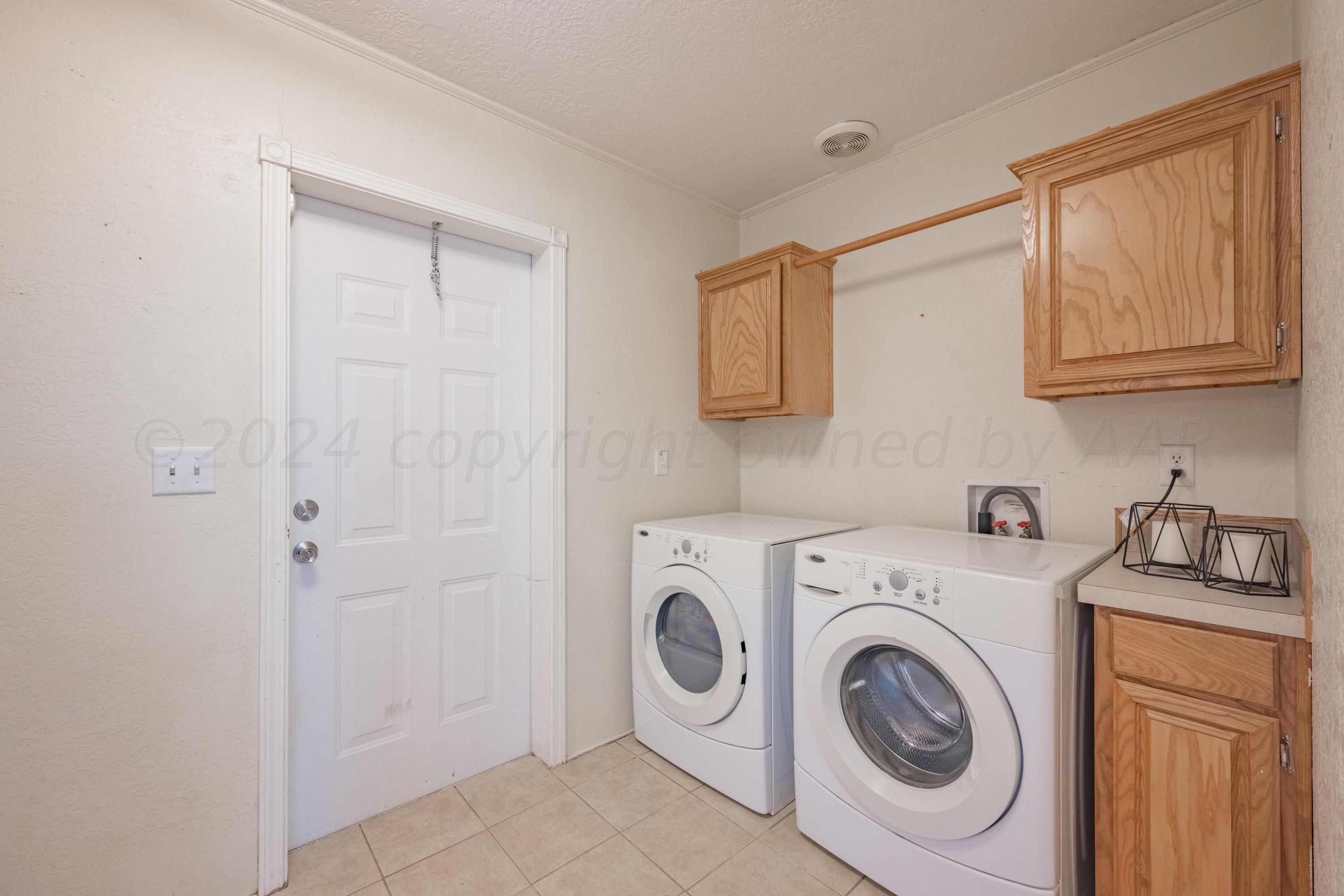 8701 Foxtail Street Amarillo, TX 79118 - Photo 16 of 33 a utility room with dryer and washer