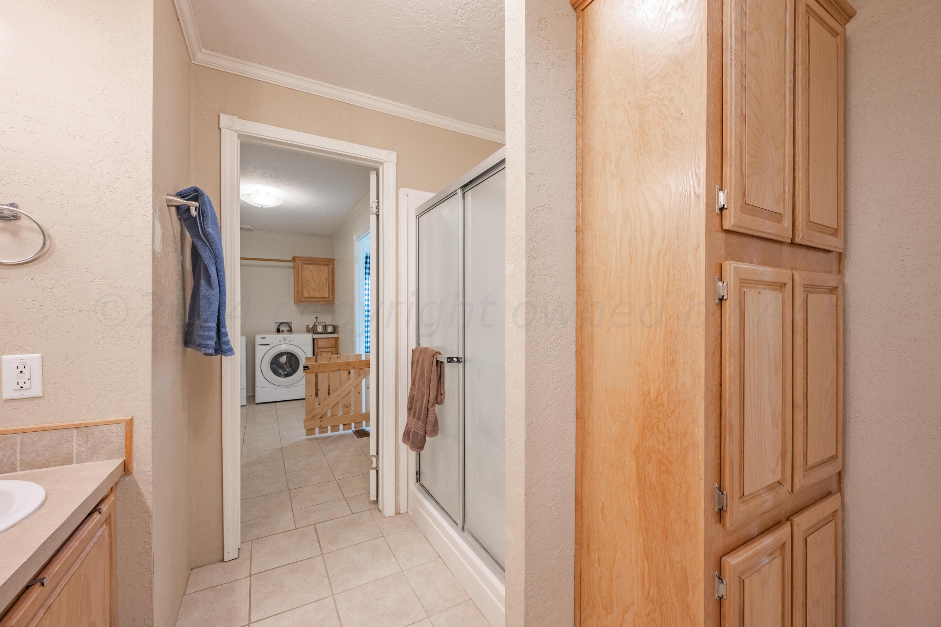 8701 Foxtail Street Amarillo, TX 79118 - Photo 19 of 33 a bathroom with a tub and shower