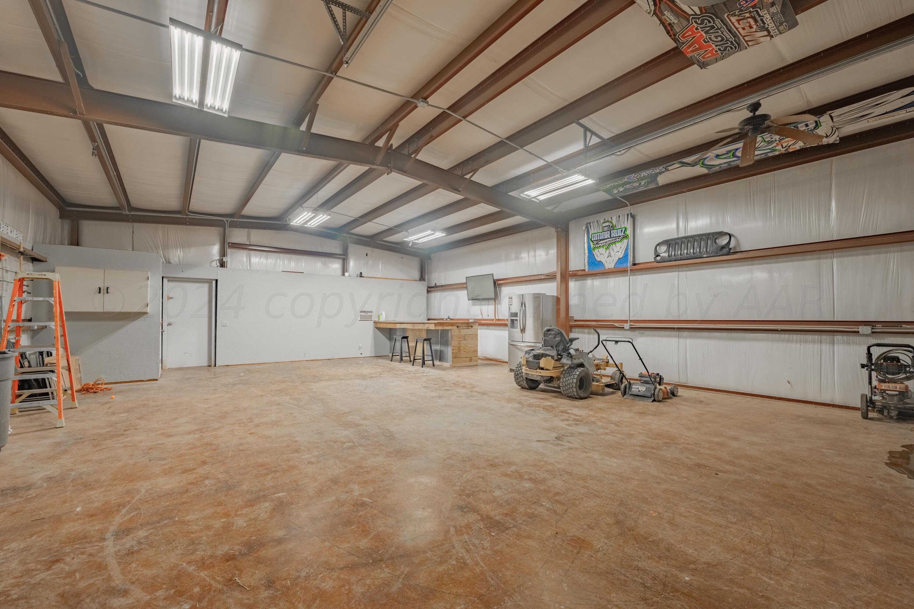 8701 Foxtail Street Amarillo, TX 79118 - Photo 32 of 33 a view of a garage with furniture