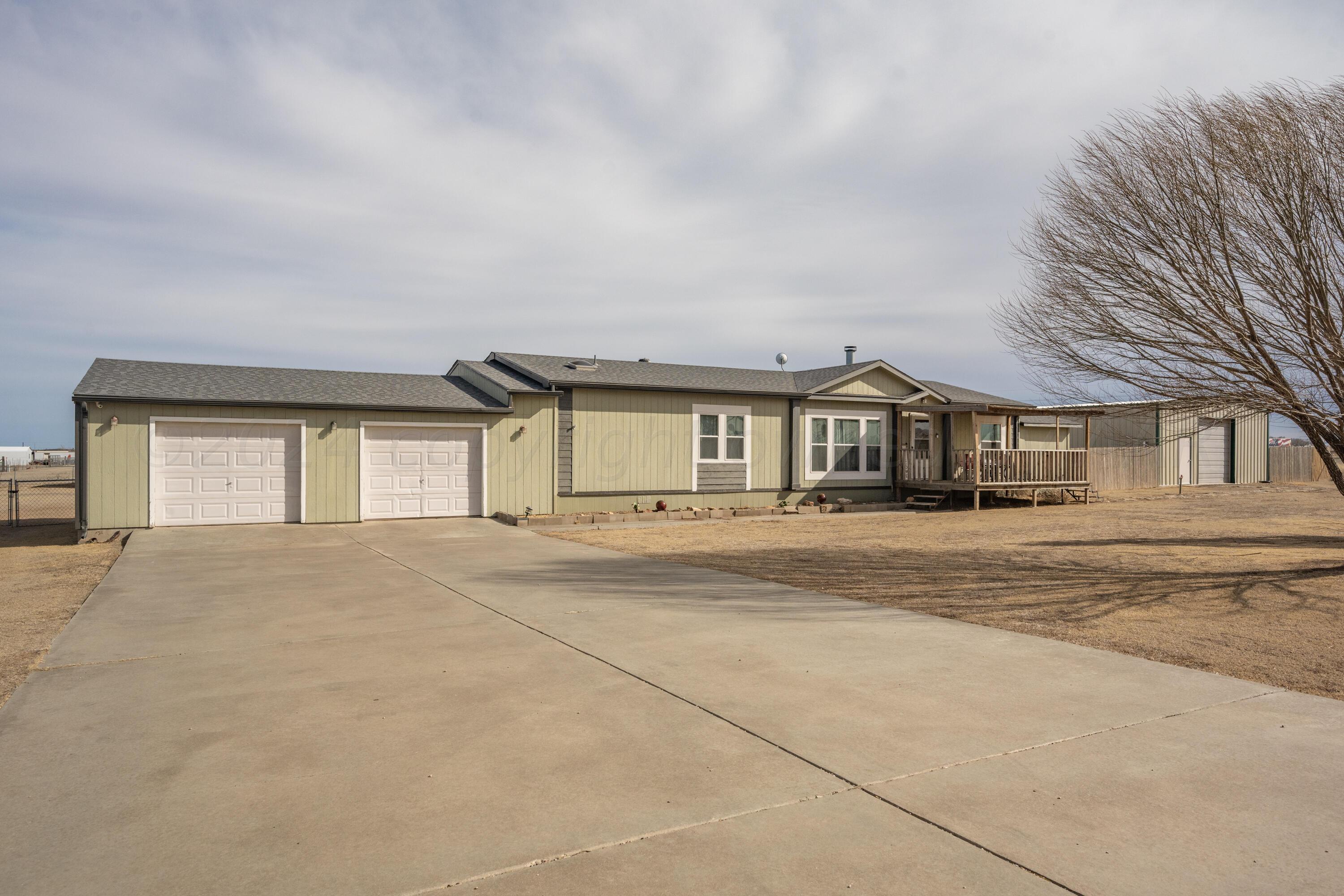 8701 Foxtail Street Amarillo, TX 79118 - Photo 4 of 33 a front view of a house with a yard and garage