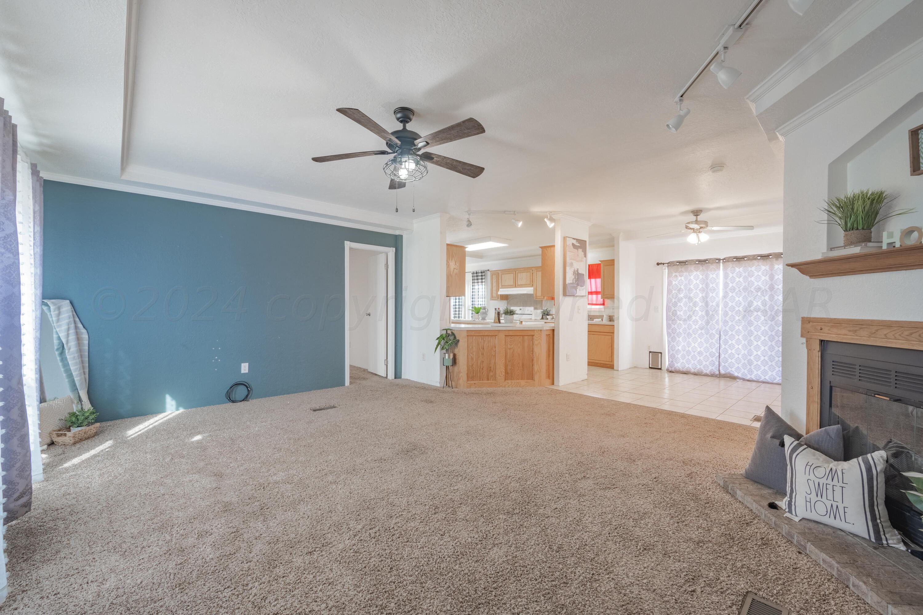 8701 Foxtail Street Amarillo, TX 79118 - Photo 7 of 33 a view of a livingroom with a fireplace and a workspace