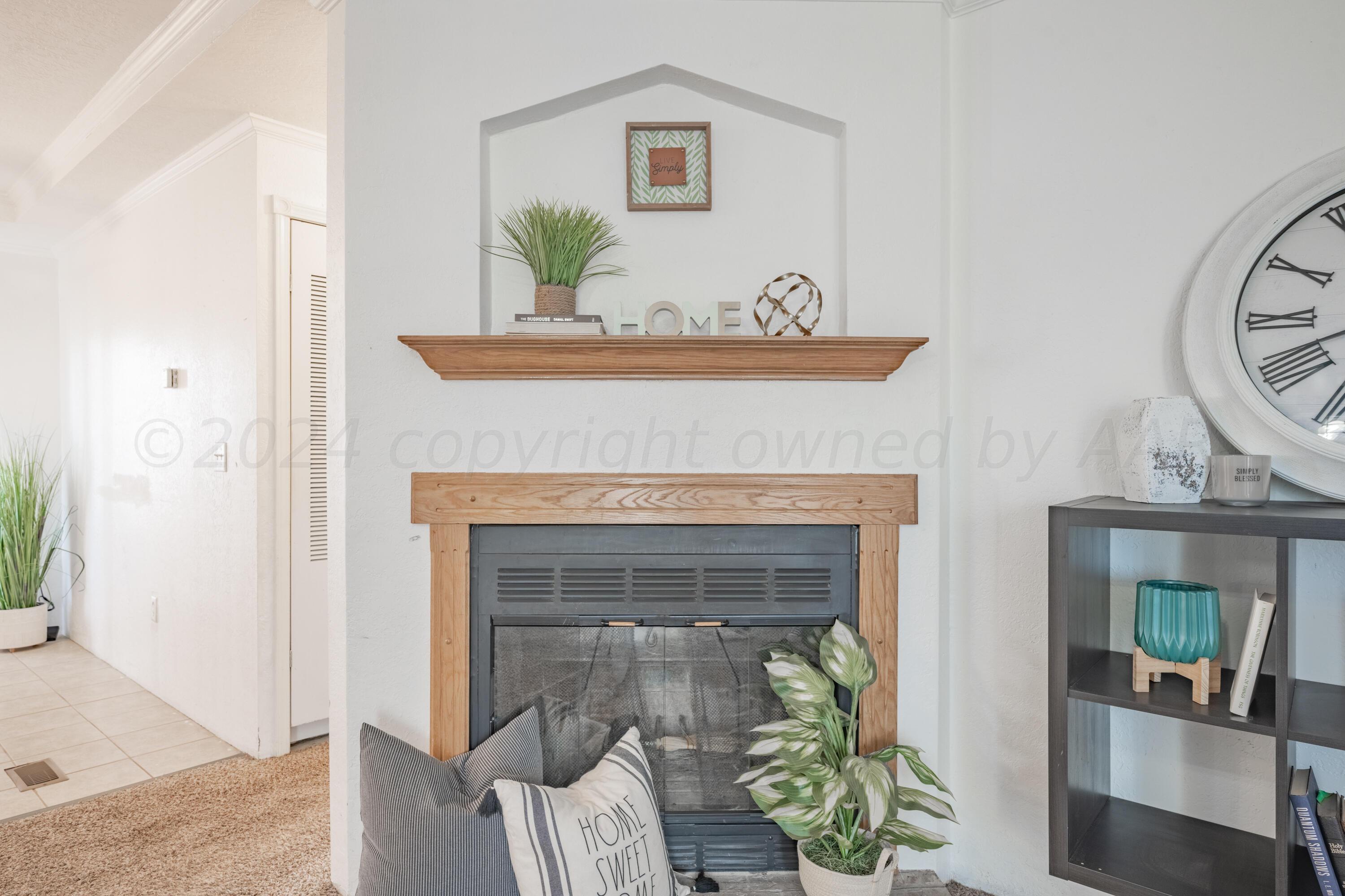 8701 Foxtail Street Amarillo, TX 79118 - Photo 9 of 33 a living room with furniture and a fireplace
