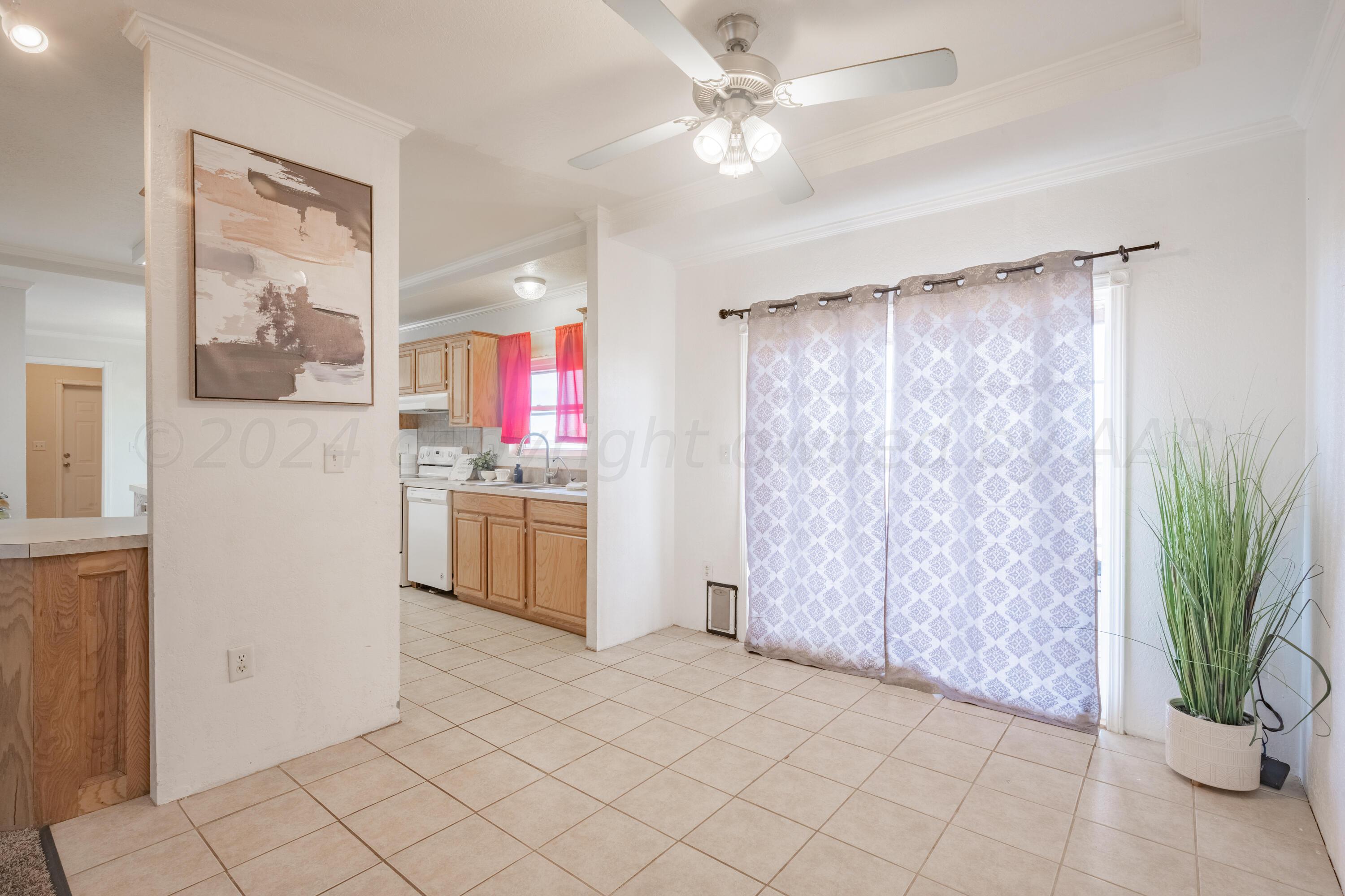 8701 Foxtail Street Amarillo, TX 79118 - Photo 10 of 33 a kitchen with stainless steel appliances a white stove top oven and a refrigerator