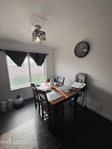 a view of a dining room with furniture and a chandelier