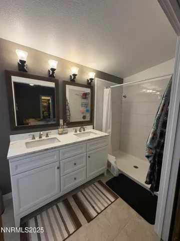 a bathroom with a sink a mirror and a shower