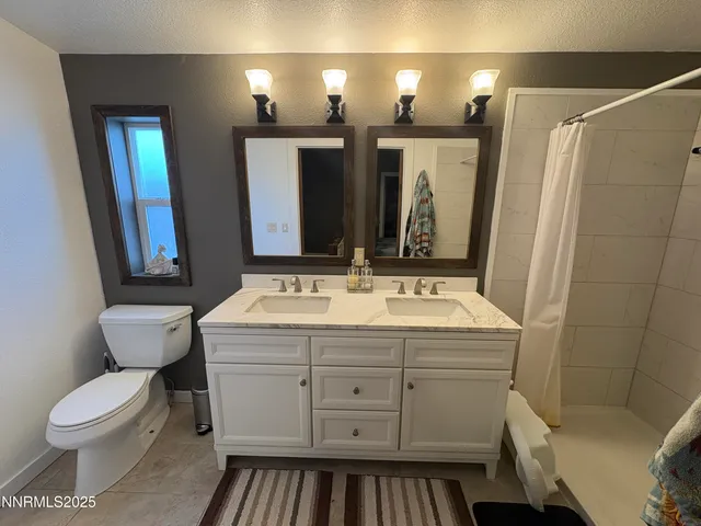 a bathroom with a sink a toilet and mirror