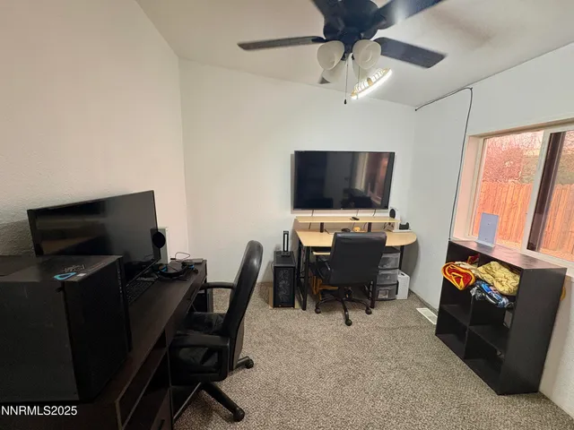a view of a livingroom with furniture and a flat screen tv