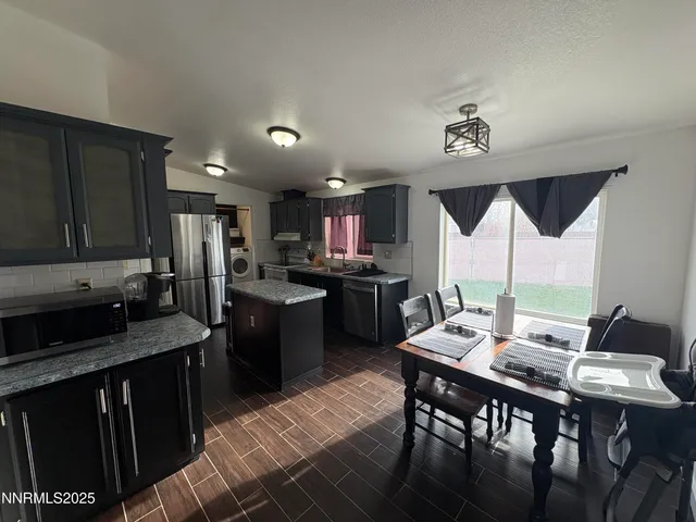 a kitchen with a table chairs stove and cabinets