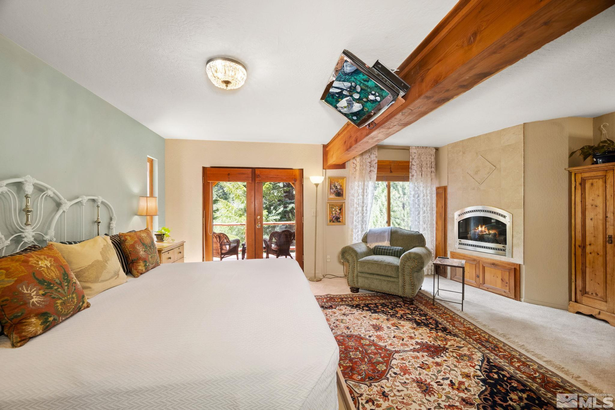 310 Barton Drive Stateline, NV 89449 - Photo 18 of 36 a bedroom with furniture and a large window