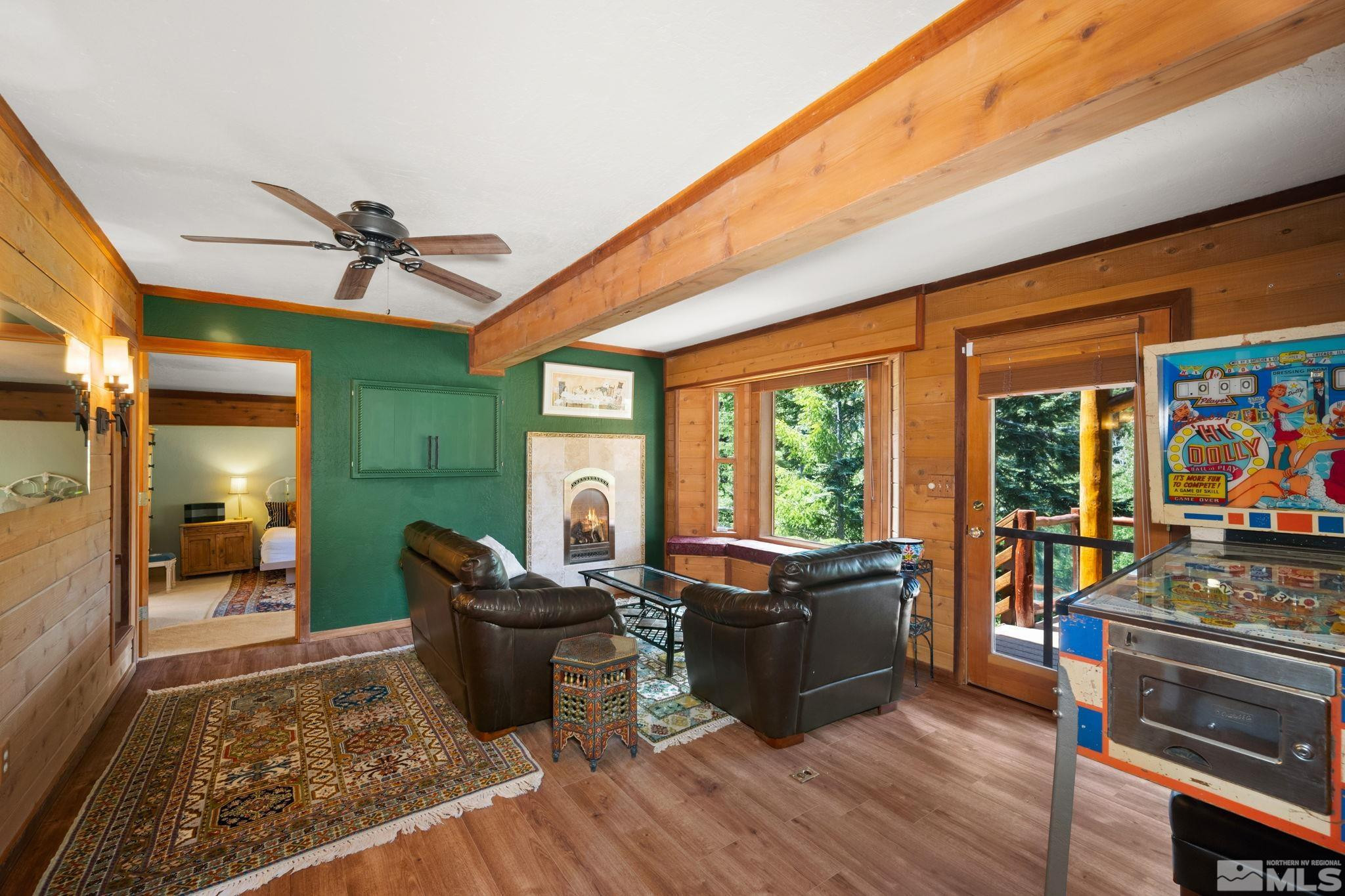 310 Barton Drive Stateline, NV 89449 - Photo 21 of 36 a living room with furniture a flat screen tv and a floor to ceiling window