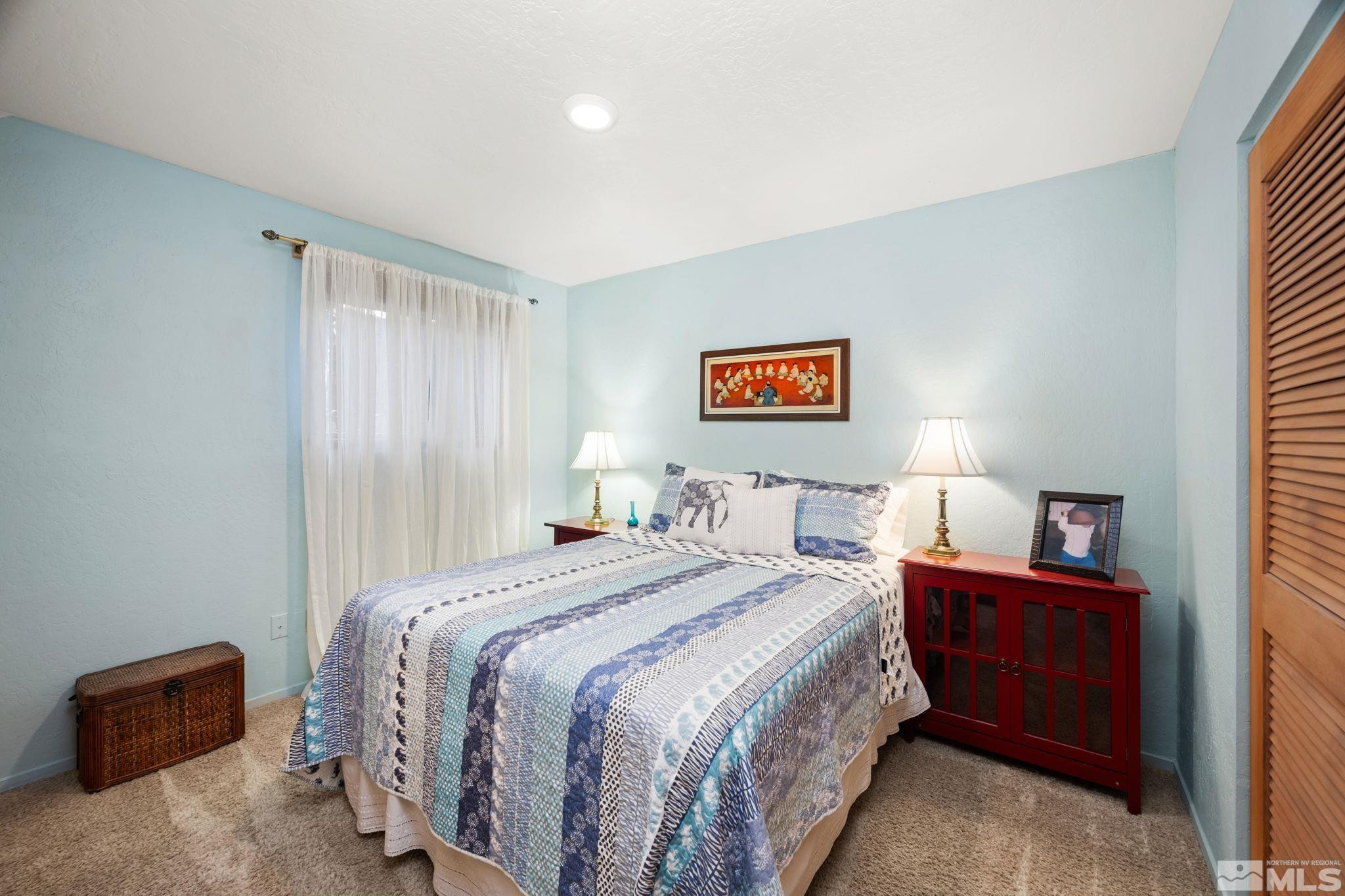 310 Barton Drive Stateline, NV 89449 - Photo 25 of 36 a bedroom with a bed and a lamp on dresser