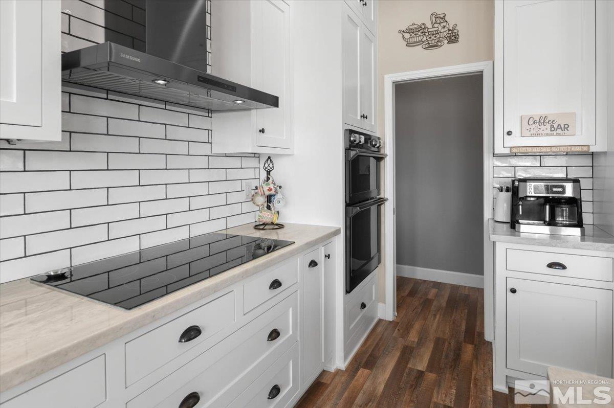 10754 Misty Meadows Drive Reno, NV 89521 - Photo 12 of 29 a kitchen with granite countertop white cabinets and stainless steel appliances