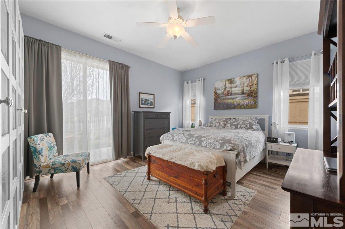 10754 Misty Meadows Drive Reno, NV 89521 - Photo 13 of 29 a spacious bedroom with a bed a couch and a window