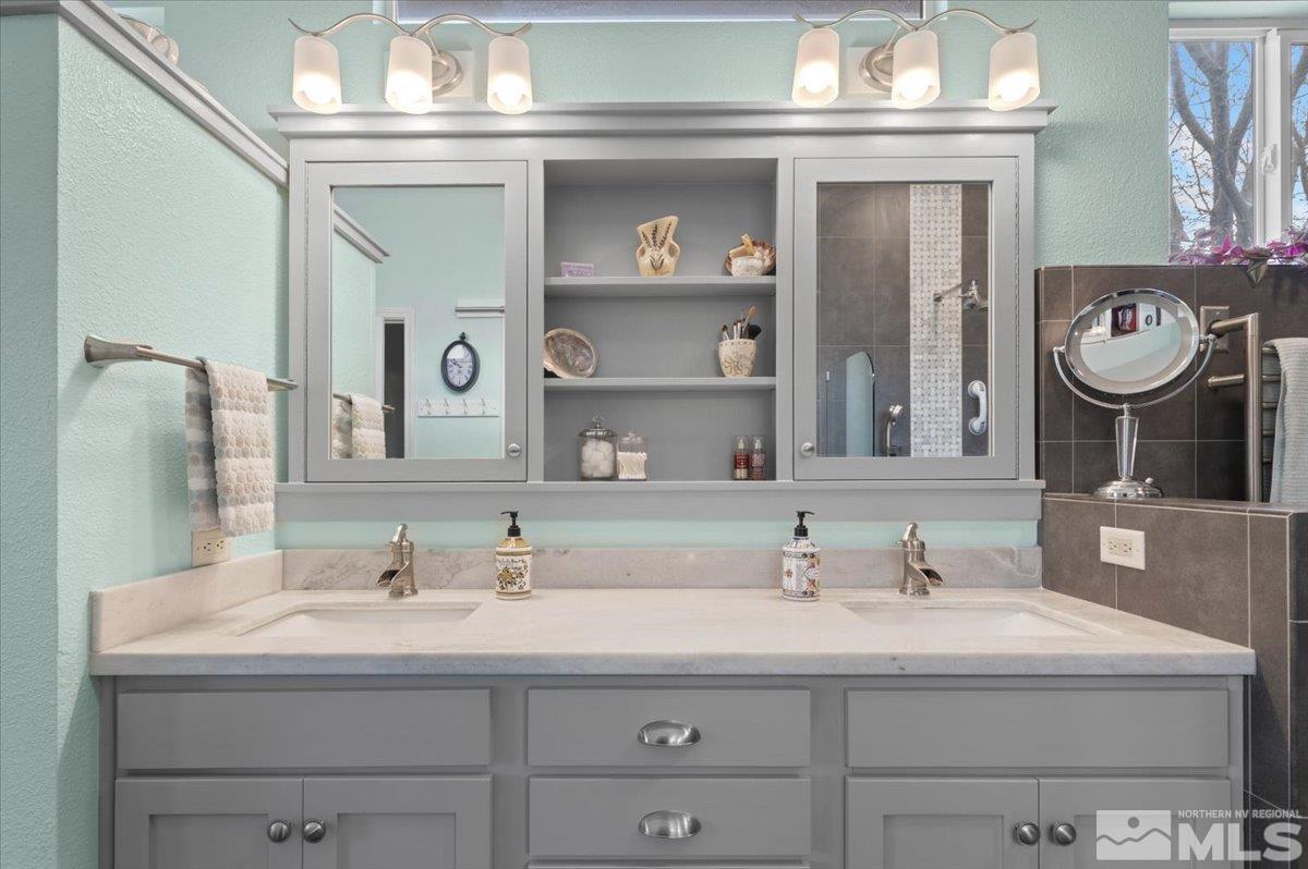 10754 Misty Meadows Drive Reno, NV 89521 - Photo 16 of 29 a bathroom with a sink and a mirror