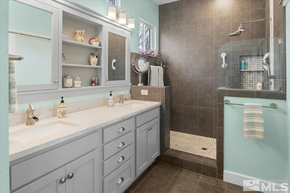 10754 Misty Meadows Drive Reno, NV 89521 - Photo 17 of 29 a spacious bathroom with a double vanity sink a mirror and shower