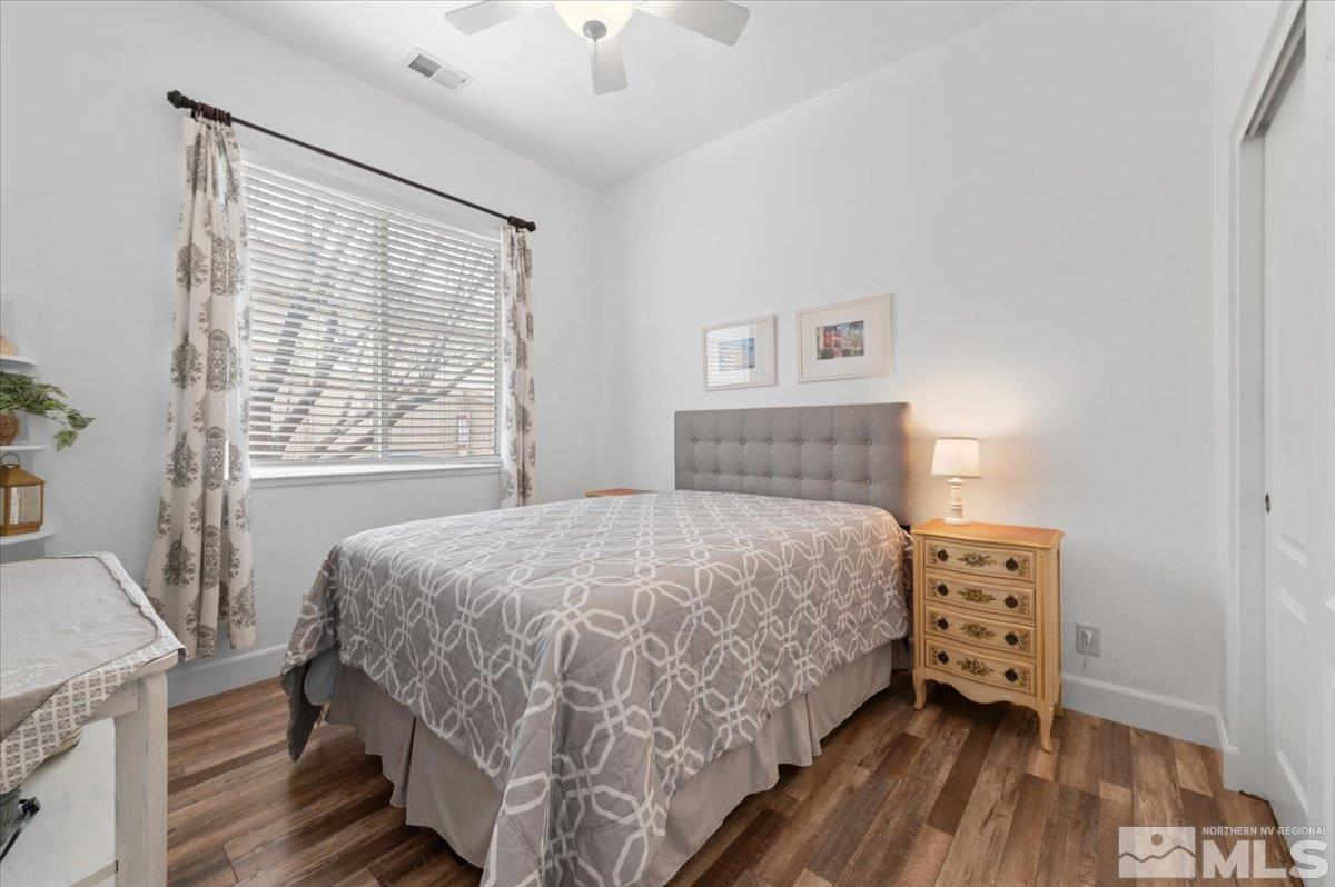 10754 Misty Meadows Drive Reno, NV 89521 - Photo 19 of 29 a bedroom with a bed and a window