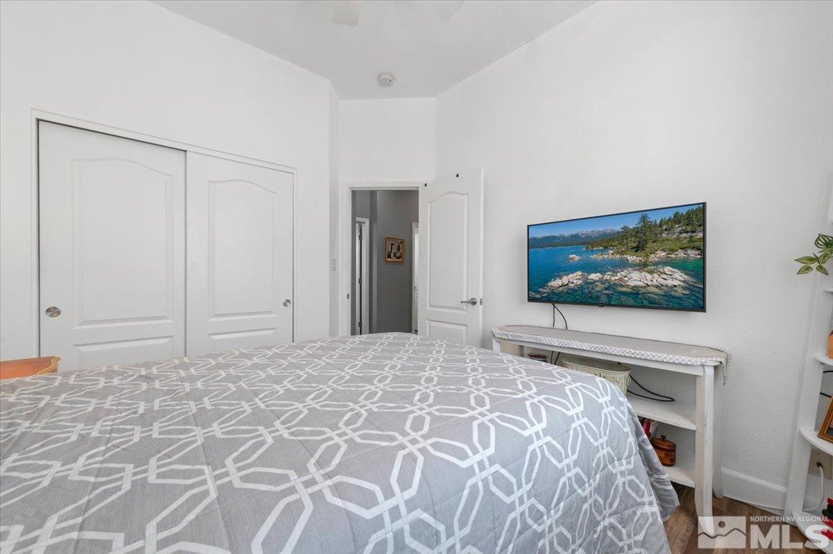 10754 Misty Meadows Drive Reno, NV 89521 - Photo 20 of 29 a bedroom with a bed and a flat screen tv