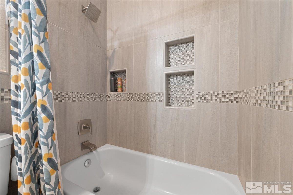 10754 Misty Meadows Drive Reno, NV 89521 - Photo 22 of 29 a bathroom with a bathtub and shower