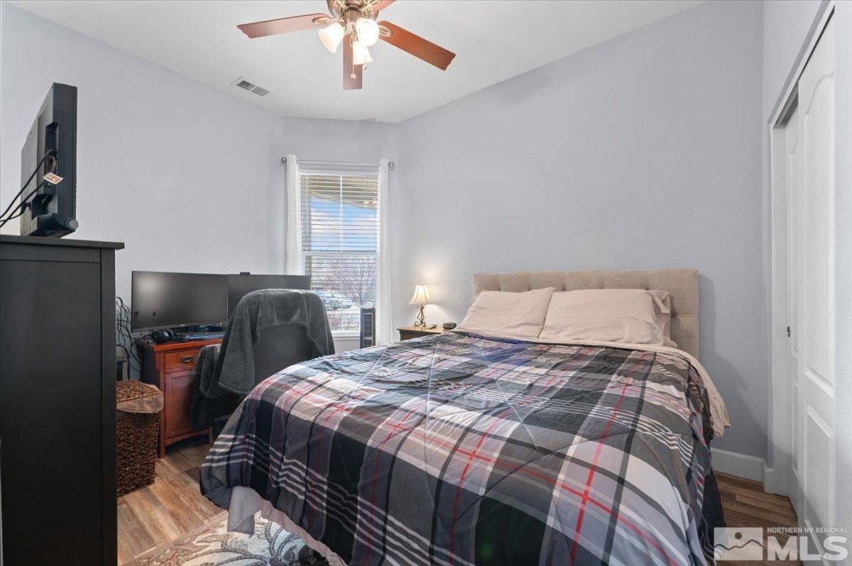 10754 Misty Meadows Drive Reno, NV 89521 - Photo 23 of 29 a bedroom with a bed and a chandelier