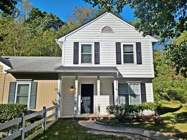 a front view of a house with a yard and porch