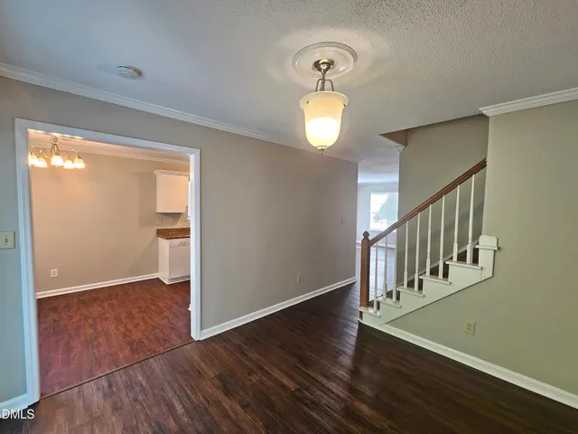 a kitchen with granite countertop a stove a sink and a microwave