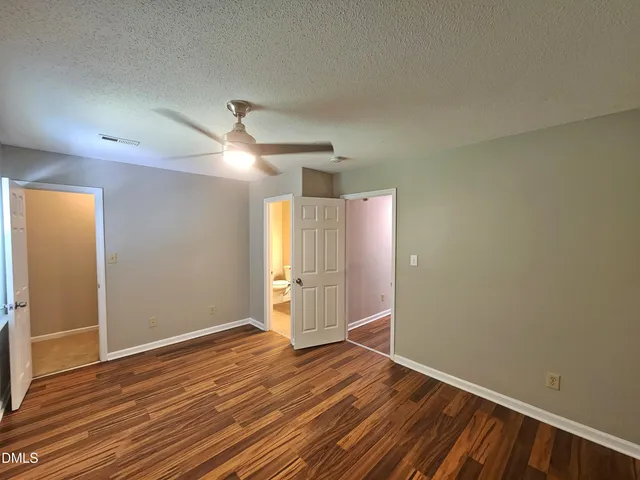 a bathroom with a granite countertop sink a toilet and a mirror