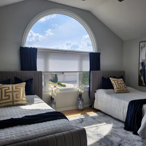 a bedroom with a large bed and window