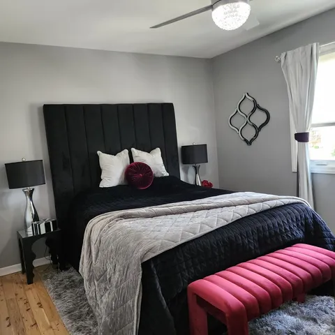 a bedroom with a bed and window